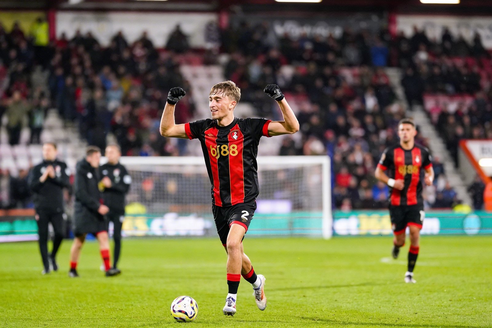 Dean Huijsen on the pitch with his hands raised