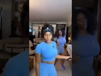 Waje and daughter wrestling playfully